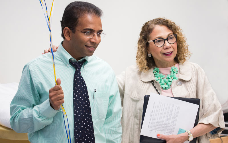 Professor Kiran George (left) with university President Mildred García.