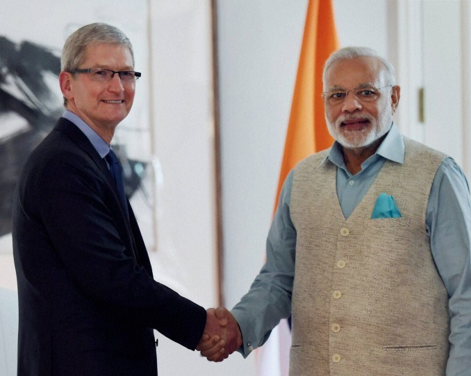 PM of India Narendra Modi, looking dapper, in a handshake with Tim Cook CEO Apple Photo courtesy: pmjandhanyojana.co.in 