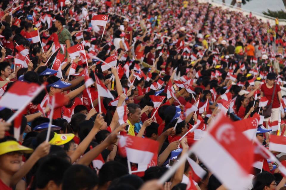 Singaporean people waving national flag