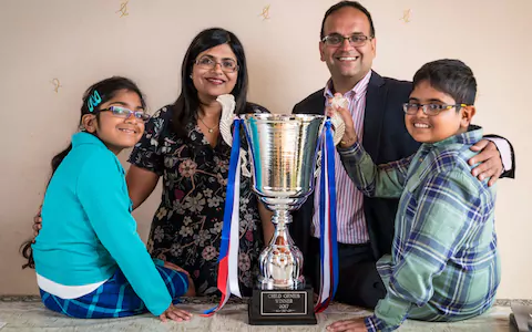 Rahul Doshi (right) with his family and the trophy.