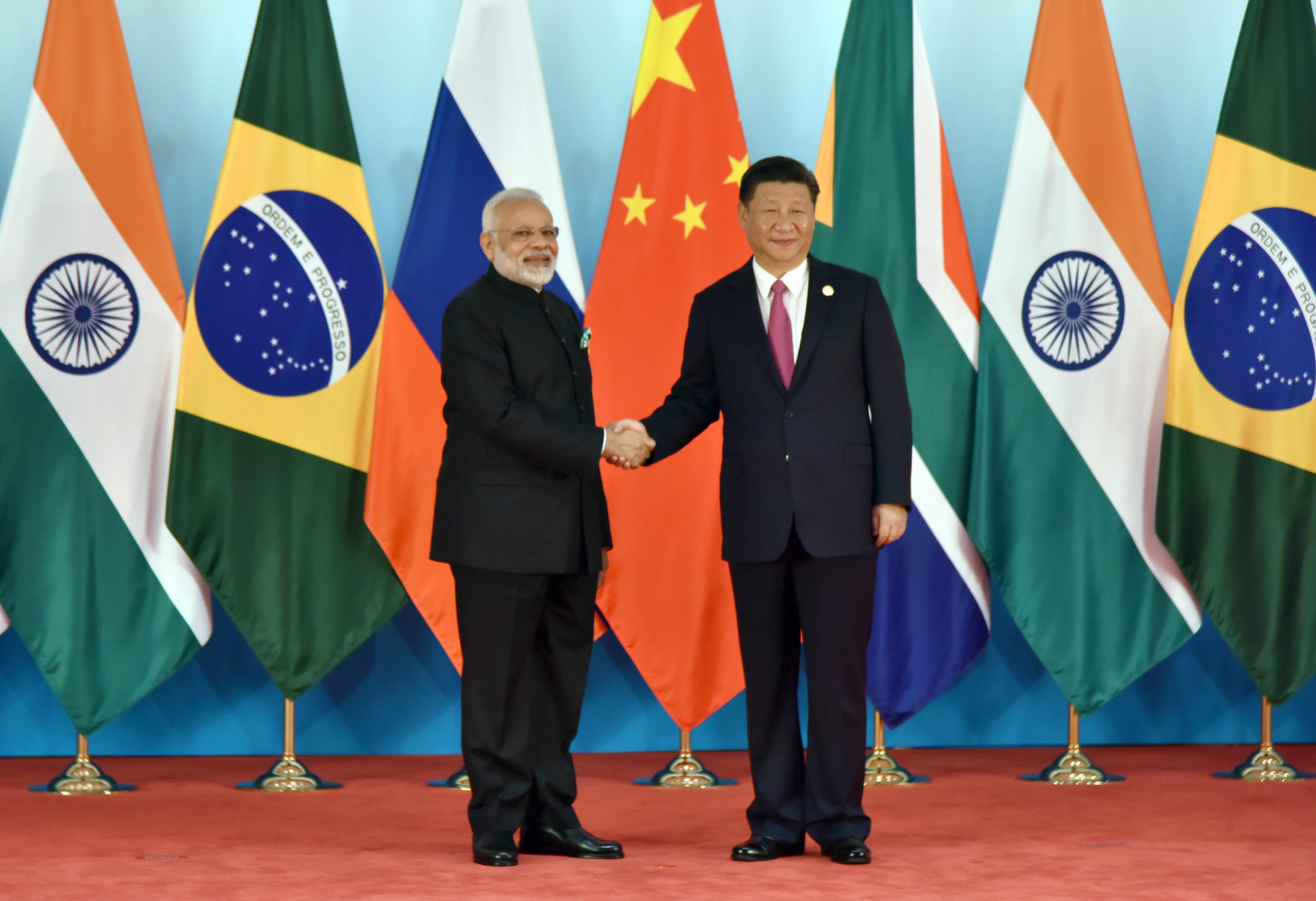 Prime Minister Narendra Modi being welcomed by the President of the People’s Republic of China Xi Jinping, at the 9th BRICS Summit, in Xiamen