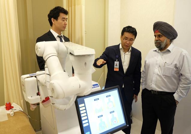 Inderjit Singh, Chairman of NTUitive, NTU’s innovation and enterprise arm, gets a demo of Emma from Albert Zhang, founder of AiTreat, and NTU PhD student Liu Kai. 