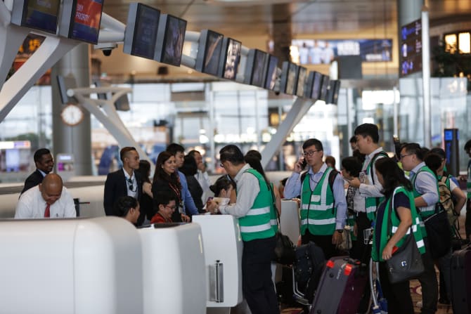Ground handling agents attending to participants'  checking-in during the dress rehearsal at Changi Airport. 