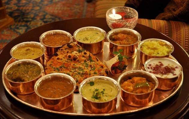 The thali is loaded with hot and spicy lentils, vegetables, sidu, which is a kind of bread and meetha bhaat (sweet rice mixed with nuts)