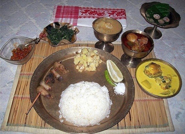 The delicious thali has meat dish, fish, fresh vegetables, aloo pitika, dal and saag