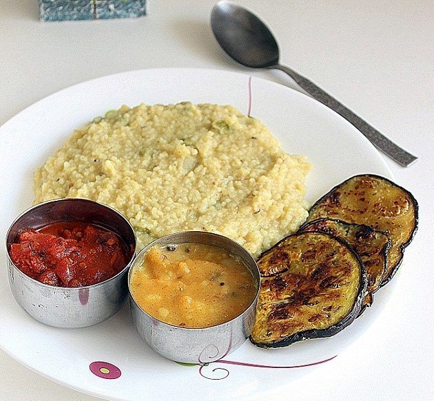 Fried aubergines, Berma, which is a small, oil-pasted & dry fermented fish, tomato chutney, lentils, rice, muya (bamboo shoot), local fishes, vegetables, herbs, batema etc are staple part of the thali