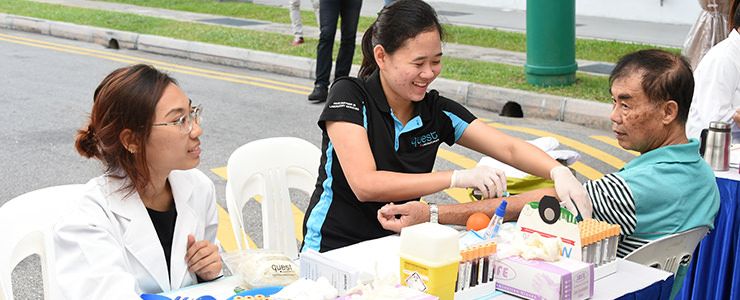 Health Promotion Board (HPB) staff examining the health of employees in Singapore. 
