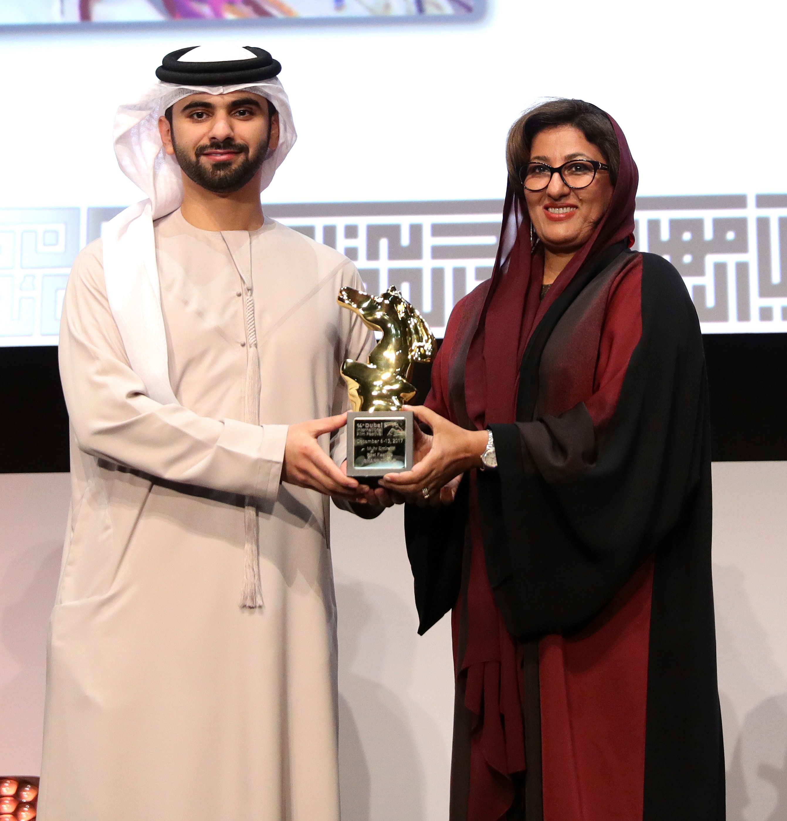 His Highness Sheikh Mansoor bin Mohammed bin Rashid Al Maktoum presenting the award of the Best Emirati Feature Film to director Nujoom Alghanem for her film 'Sharp Tools'. 