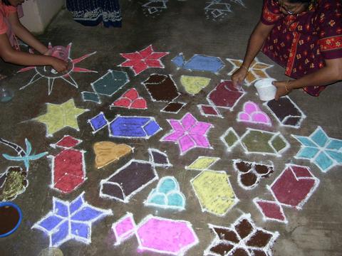 Kolam is drawn in front of houses.