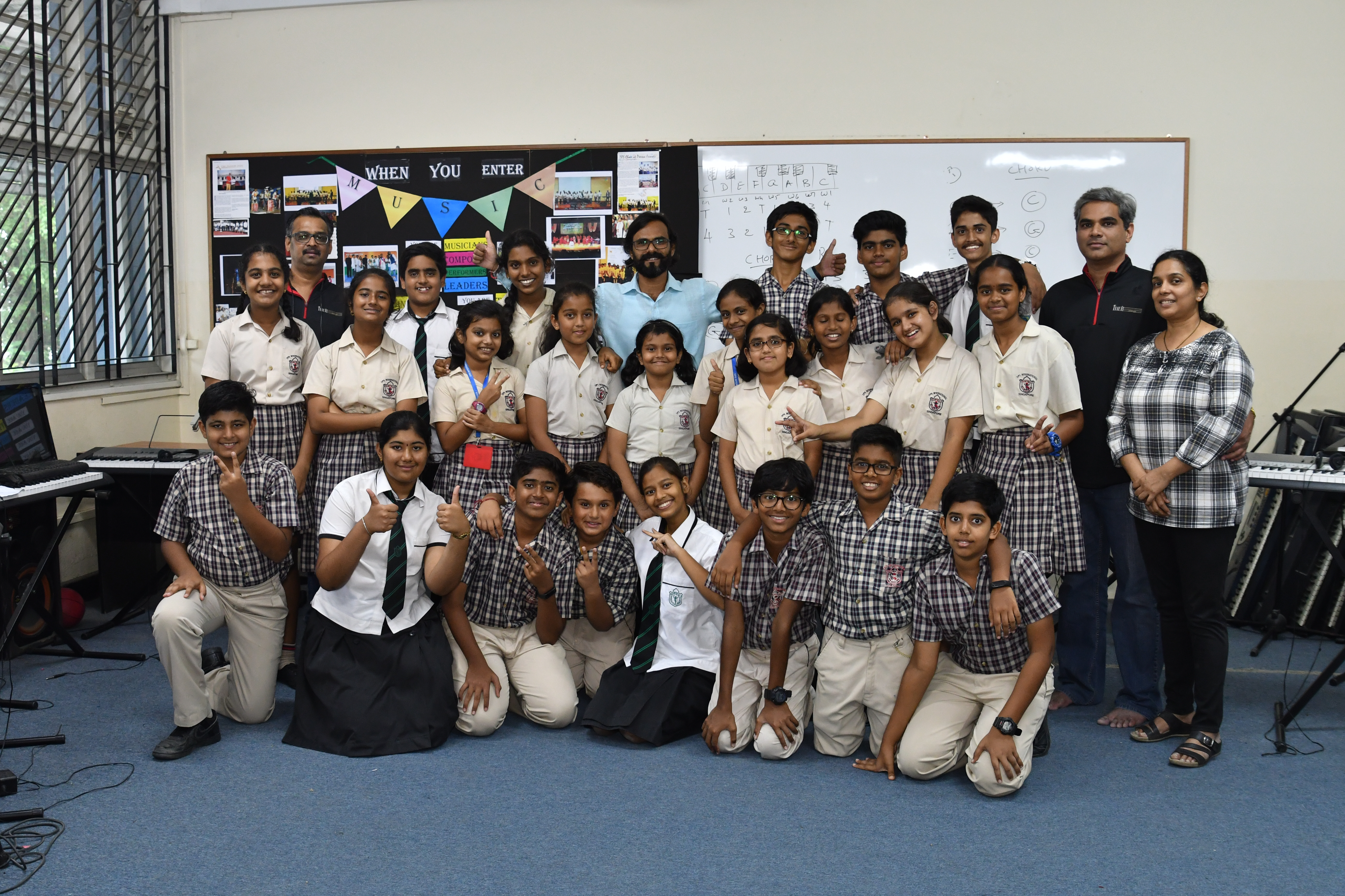 features about 500 students, teachers and the school choir singing in English, Hindi and 10 other Indian languages