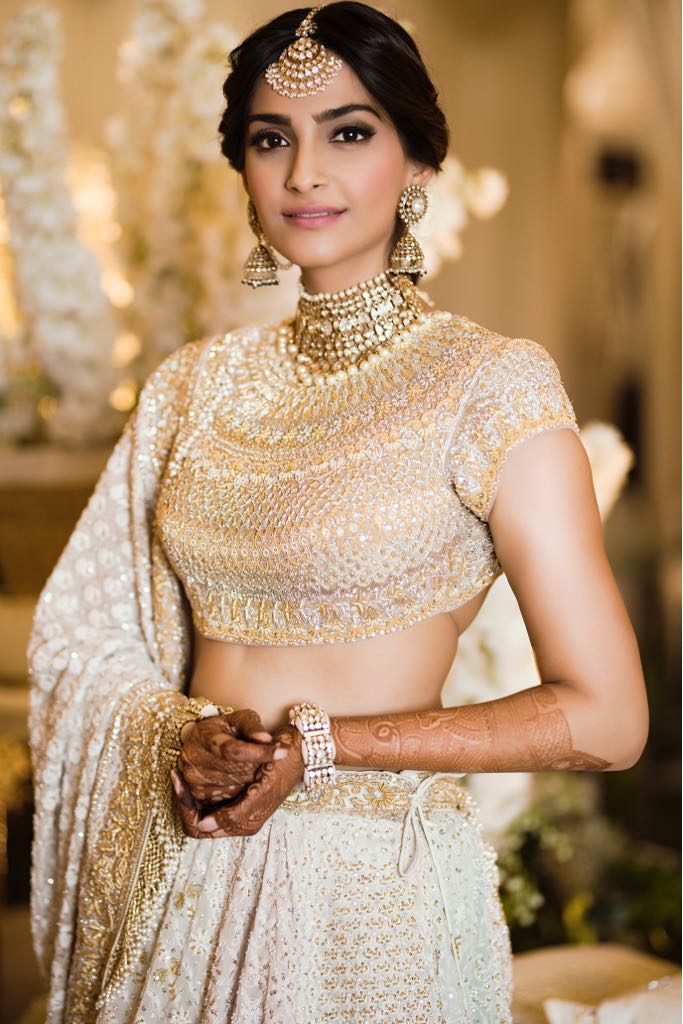 Sonam Kaooor is dressed in white and golden for her mehendi ceremony.