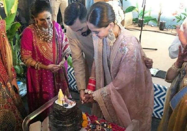 The newlyweds cut the cake after the wedding ceremony today. 