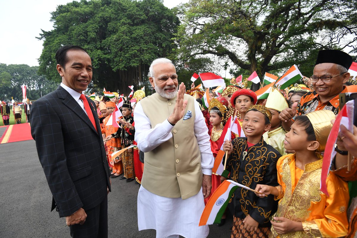 Indonesian President Joko Widodo welcomes Indian Prime Minister Narendra Modi at the Merdeka Palace. Children dressed in Indonesian national attire and waving Indonesian and Indian flags touched the heart of Indian PM as he later acknowledged in a joint press conference today.