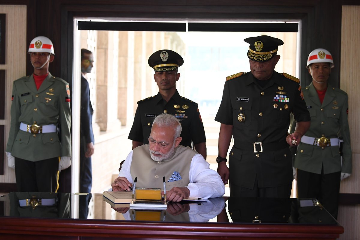 Indian Prime Minister Narendra Modi signing the visitor's book at the Kalibata National Heroes Cemetery in Jakarta.
