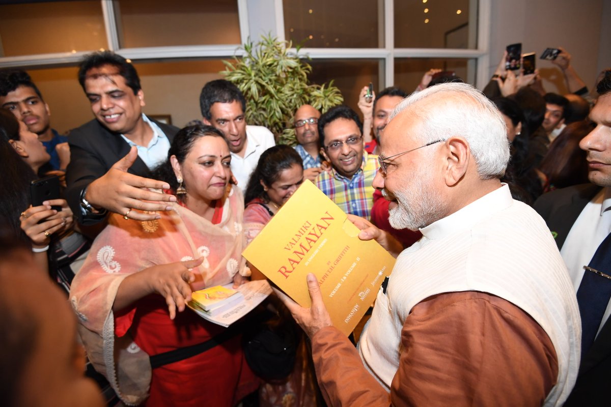 One of the members of Indian community presenting Valmiki Ramayana to the Indian Prime Minister Narendra Modi in Jakarta. Photo courtesy: Twitter page of PM Narendra Modi