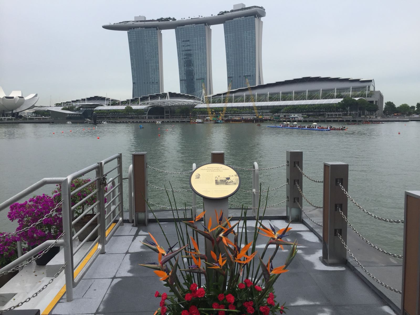  A view of Marina Bay from Clifford Pier with the board containing details about the immersion of Mahatma Gandhi’s ashes  in the foreground.
