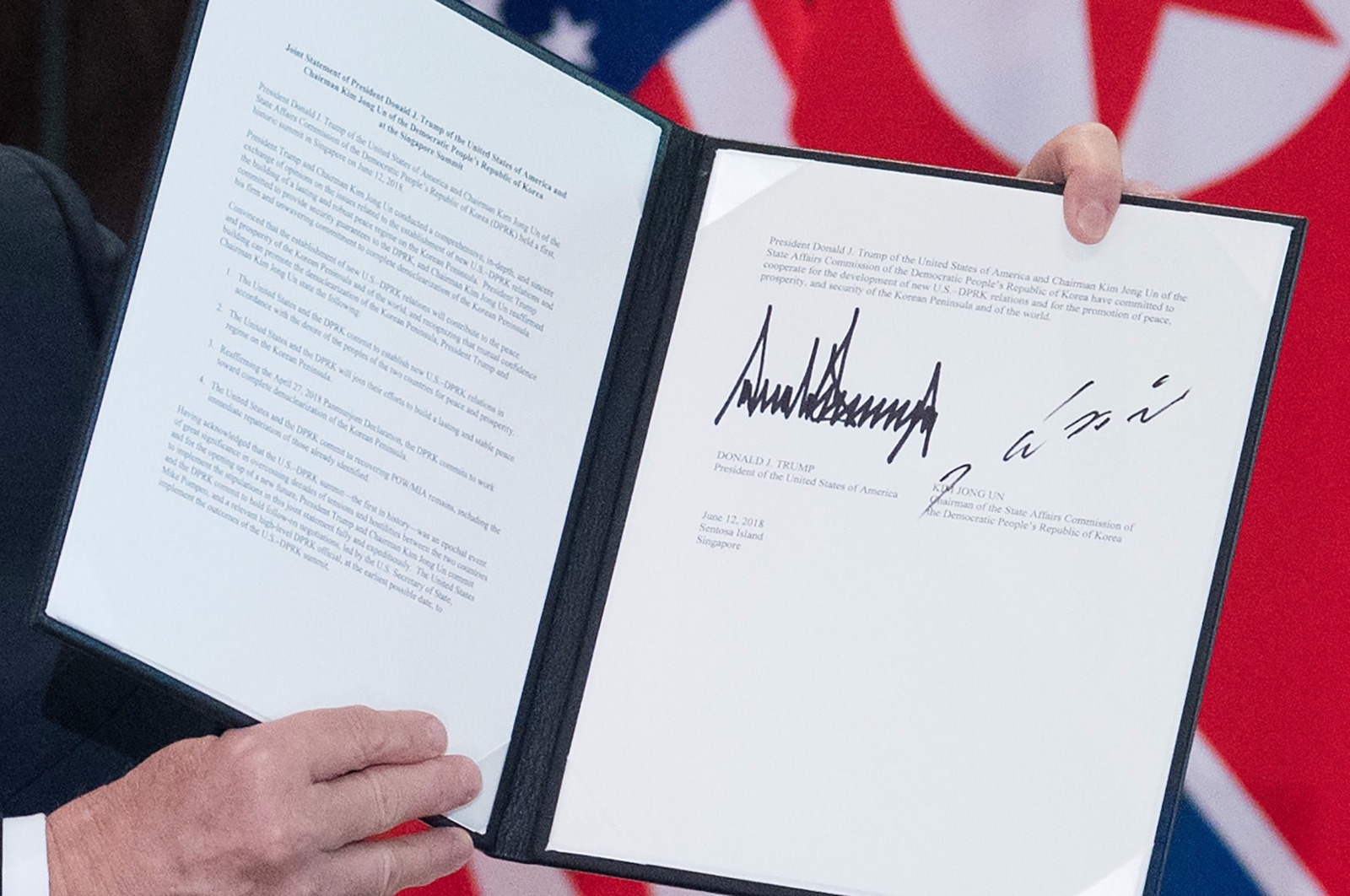 The signatures of US President Donald Trump and North Korea's leader Kim Jong Un are seen on a document following a signing ceremony during their historic US-North Korea summit. Photo courtesy: Ministry of Communications and Information