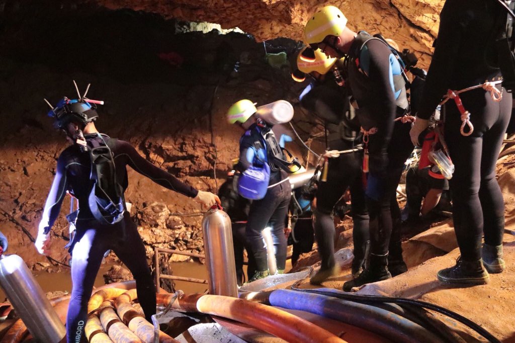 Two divers were assigned to each child to help them navigate the dangerous, narrow passageways.