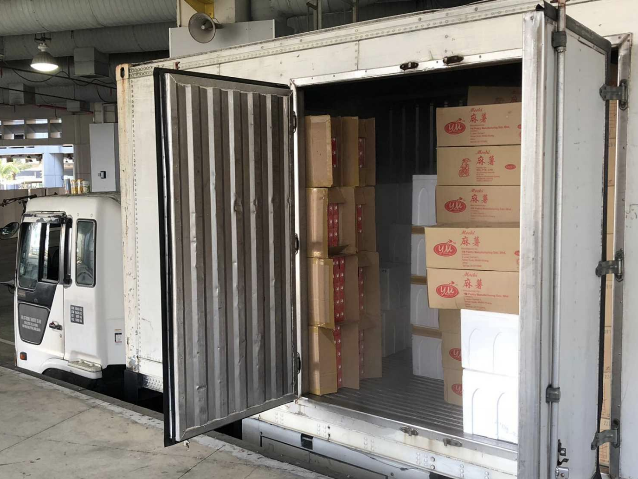Duty-unpaid cigarettes found concealed in the consignment declared to be frozen food. Photo courtesy: ICA