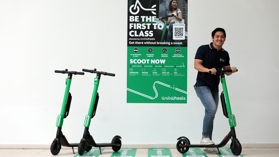 The new GrabWheels service offers NUS students such as Nicholas Tey, an alternative to taking the shuttle buses, especially when they are in a hurry and the bus has yet to arrive. Photo courtesy: NUS