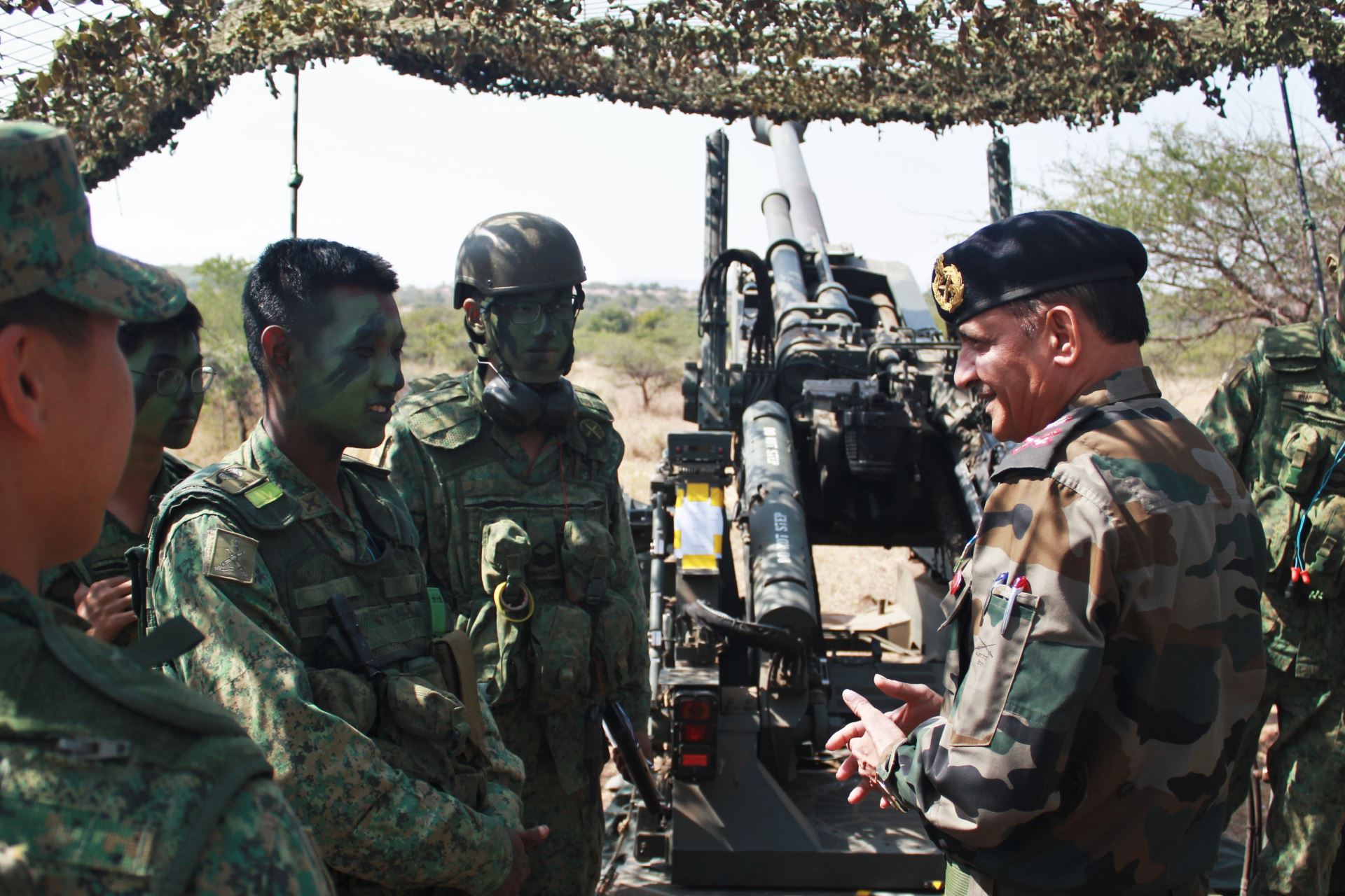 Soldiers from the Singapore Army interacting with the chief artillery instructor of the Indian Army in an informal exchange.  (Photo courtesy: Ministry of Defence, Singapore