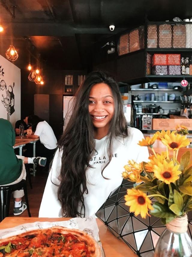 Caught smiling with pizza at the cafe. Photo courtesy: Manasi Jain