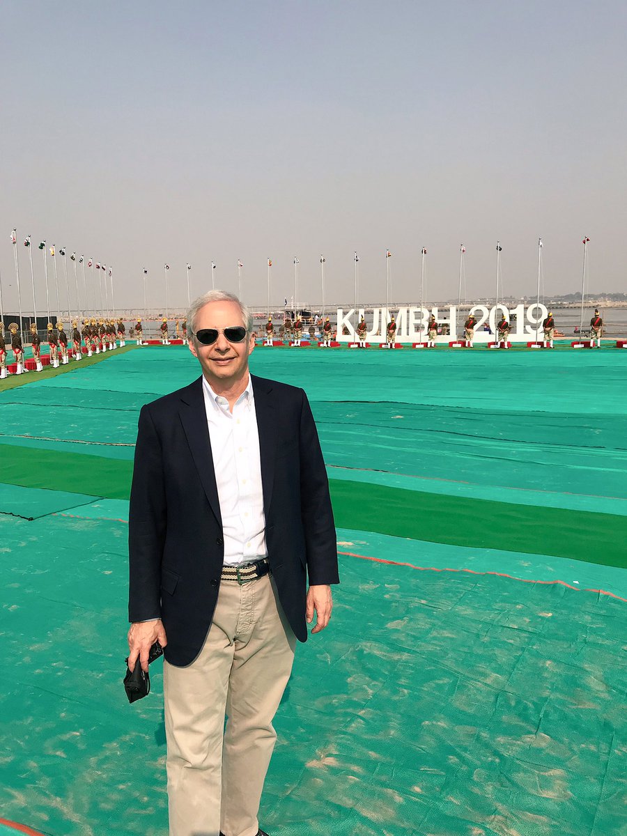 US Ambassador to India Ken Juster poses in backdrop of Kumbh venue with flags of 71 nations (Photo courtesy: Ken Juster, Twitter