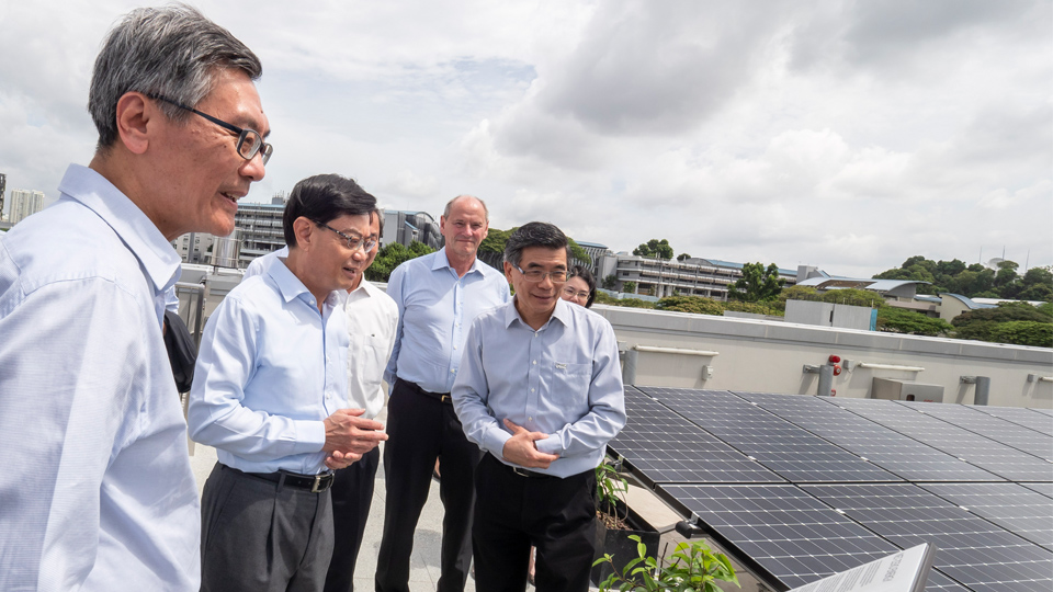 Mr Heng Swee Keat, Minister for Finance and Chairman of the National Research Foundation, viewing the rooftop photovoltaic panels at SDE4, Singapore’s first new-build net-zero energy building. Photo courtesy: NUS
