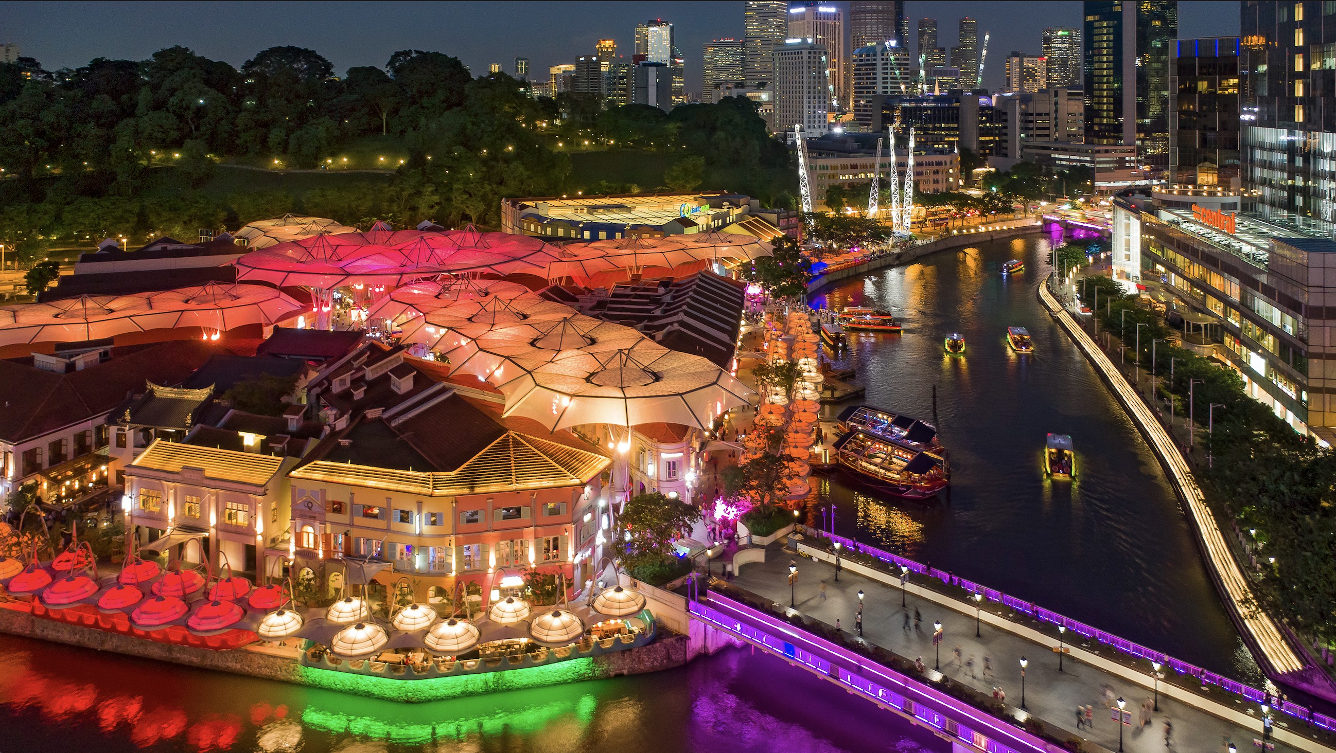 Nighttime aerial image of Clarke Quay, with lights, Singapore River, Fort Canning and civic district in the background. Photo courtesy: Lim Wei Xiang/STB