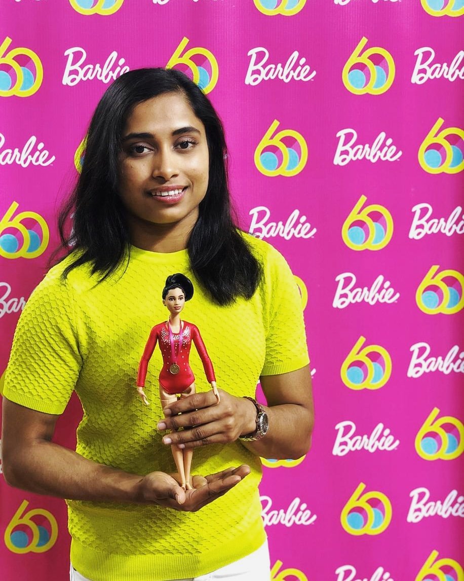 The doll that represents Karmakar is dressed in a red leotard singlet with a tight bun and a bronze medal. 