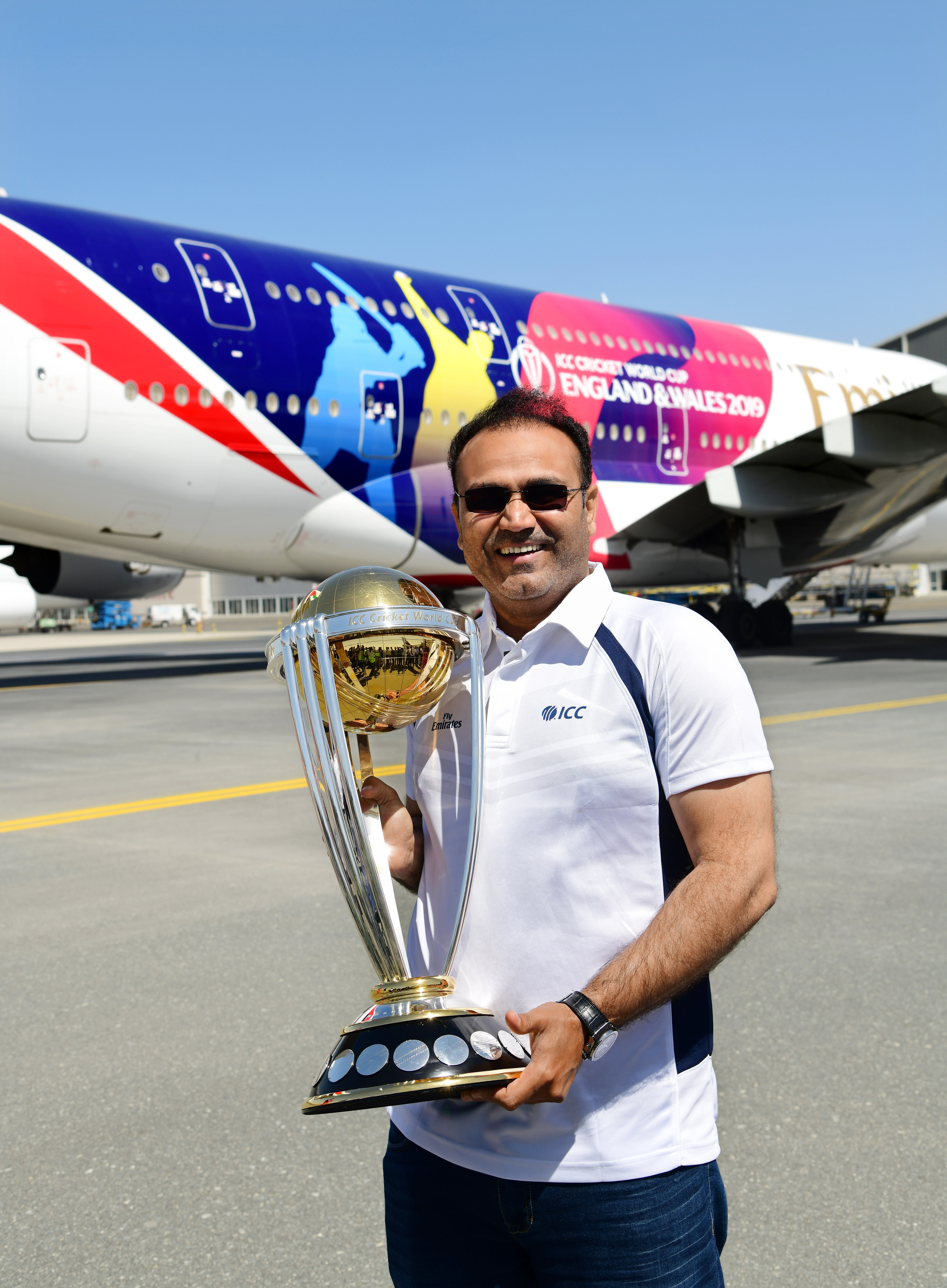     Virendra Sehwag holding ICC Men’s Cricket World Cup trophy. Photo courtesy: Emirates