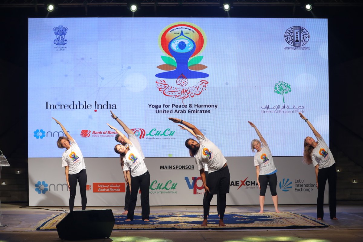 Yoga experts teaching intricacies of yoga exercises to the people at Abu Dhabi. Photo courtesy: Twitter/@IndembAbuDhabi