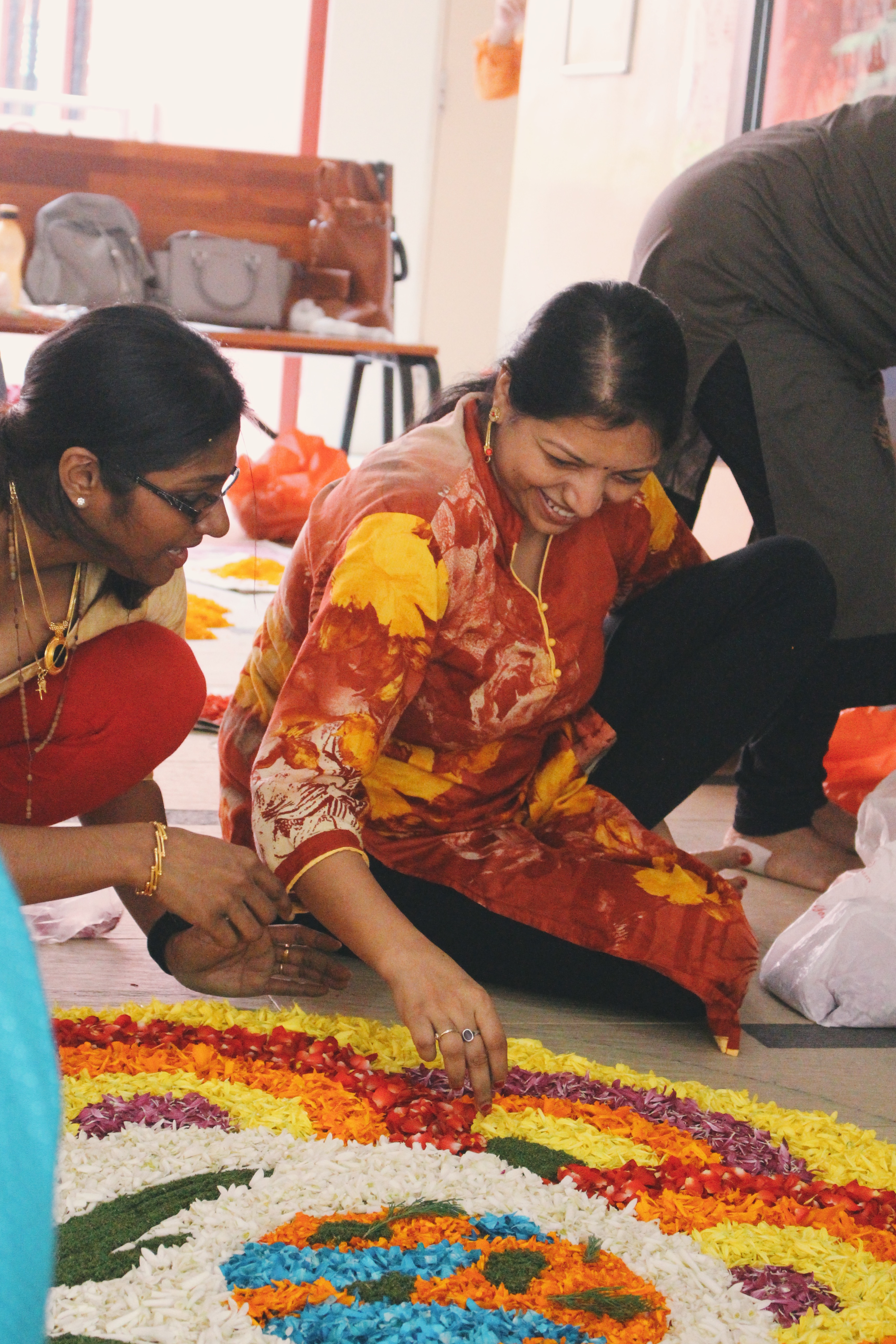 Participants hard at work at the 'Pookalam' competition. Photo: Connected to India