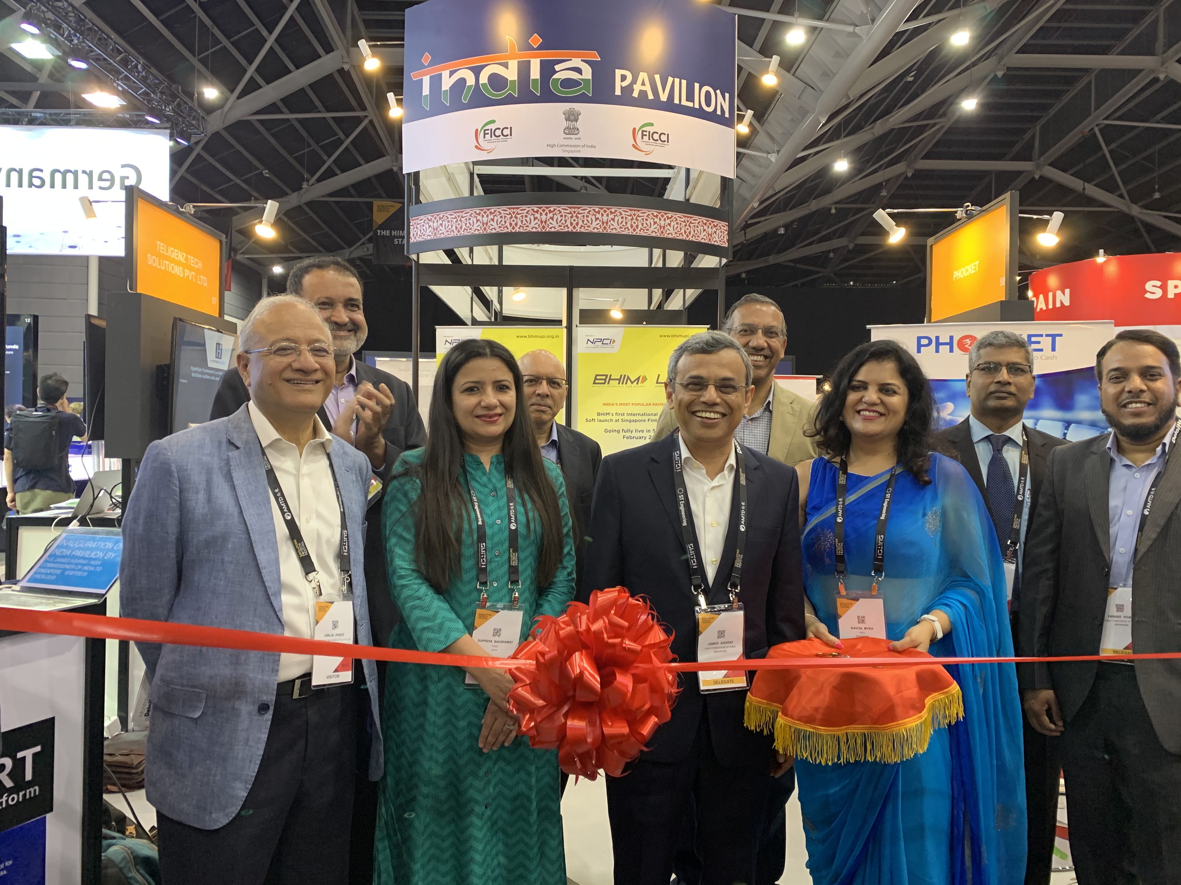 HE Jawed Ashraf, HCI Singapore, (centre) at the ribbon-cutting ceremony for the India Pavillion at the 4th Singapore FinTech Festival 2019. Also seen in the picture are Girija Pande (left), Mohandas Pai, Chairman, Aarin Capital, (2nd from left, back row), Puneet Pushkarna, Chairman Emeritus - TiE Singapore (2nd from right, back row), Navita Myer, Director, FICCI Singapore (2nd from right, front row) and Kishore Kumar Poludasu, Country Head of SBI Singapore (right, back row). Photo: Connected to India