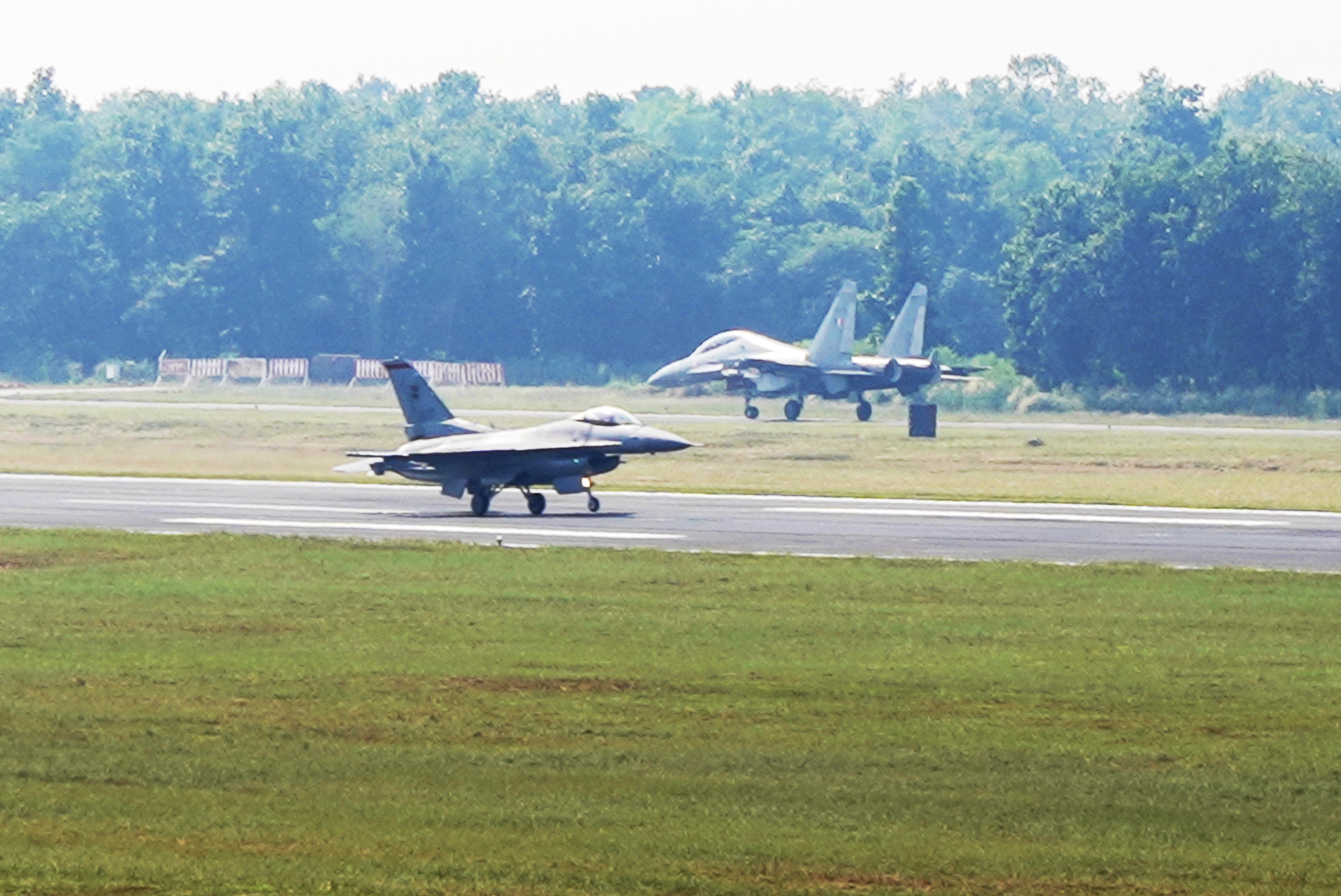 An RSAF’s F-16C (foreground) and an India Air Force’s (IAF) SU-30MKI fighter aircraft (background) at the Kalaikunda Air Force Station runway before take-off as part of JMT 19. Photo courtesy: MIndef