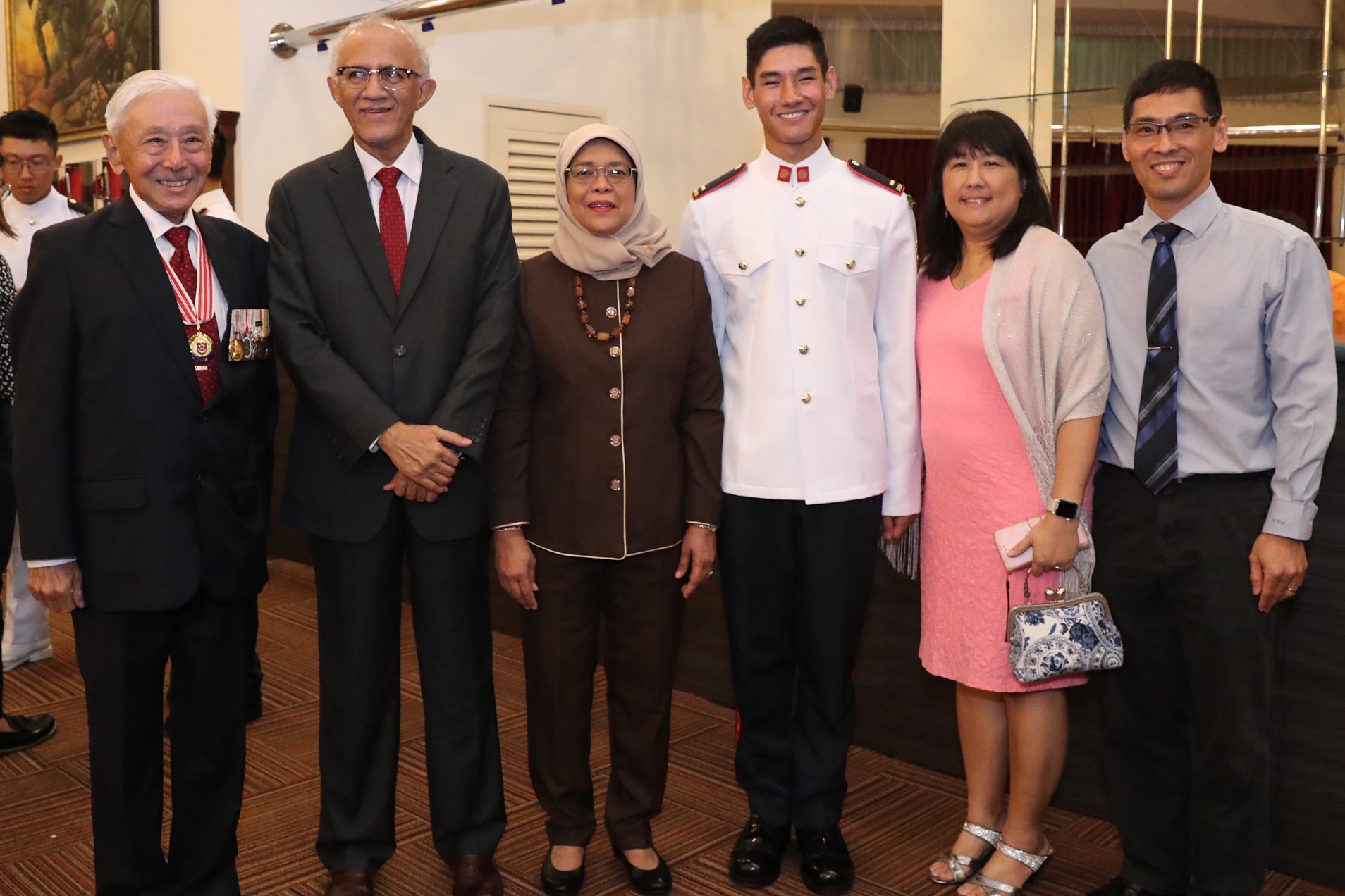 President Halimah with General Winston Choo (first from left), Singapore's first Chief of Defence Force and his grandson, 2LT Daniel Choo (third from right) who was commissioned as SAF officer this evening. Photo courtesy: MCI, Clement