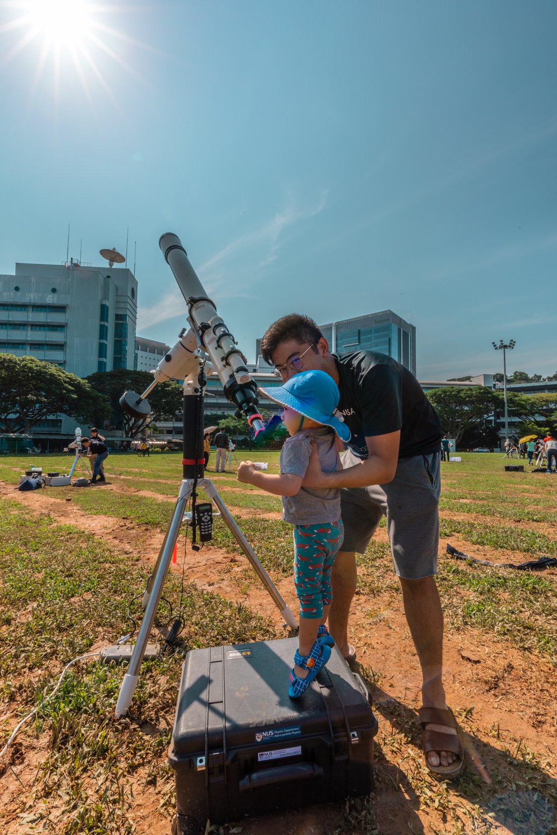 NUS School of Computing undergrad and NUS Astronomical Society President Brian Arcillas showing a young visitor how to view the sun through a telescope. Photo courtesy: NUS