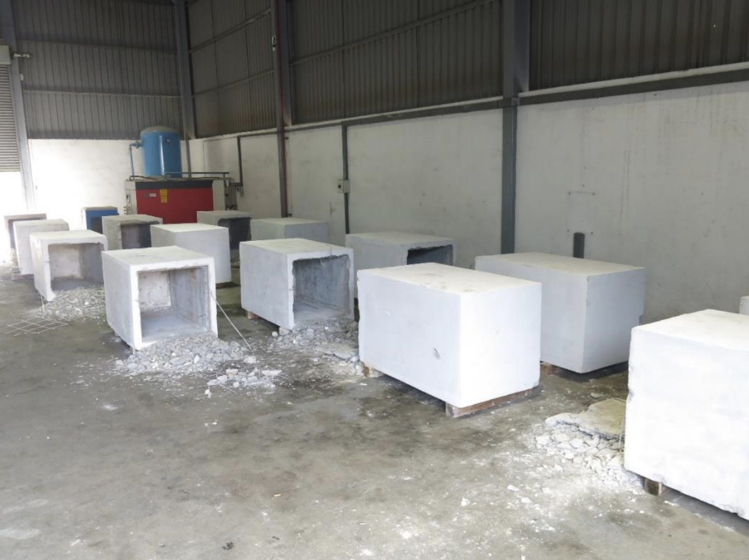 14 concrete blocks which had concealed the duty-unpaid cigarettes were found during the follow-up search at an industrial unit in Gul Road. Photo courtesy: Singapore Customs