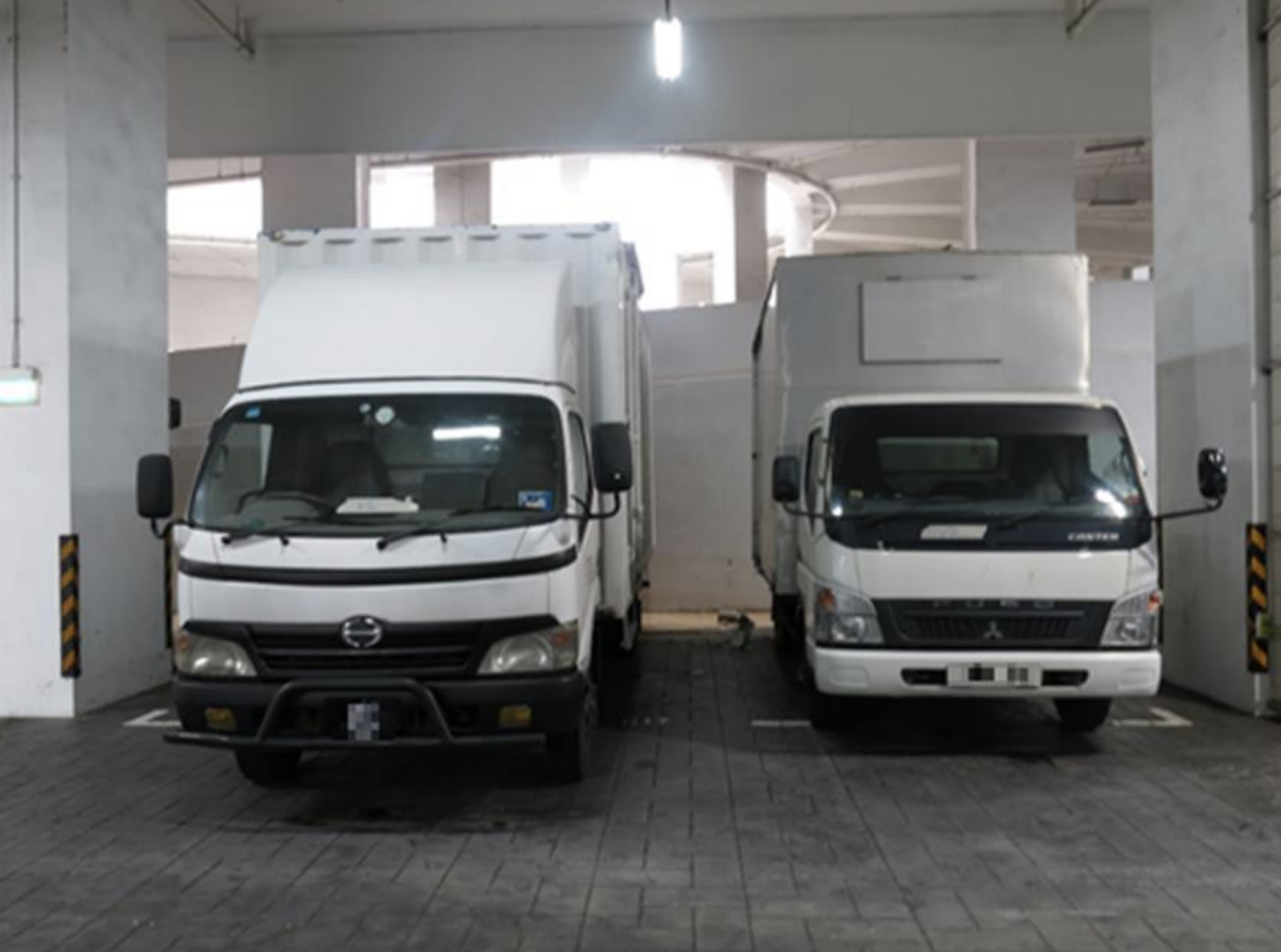 Officers uncovered duty-unpaid cigarettes in two trucks found at the vicinity of Sunview Road. Photo courtesy: Singapore Customs