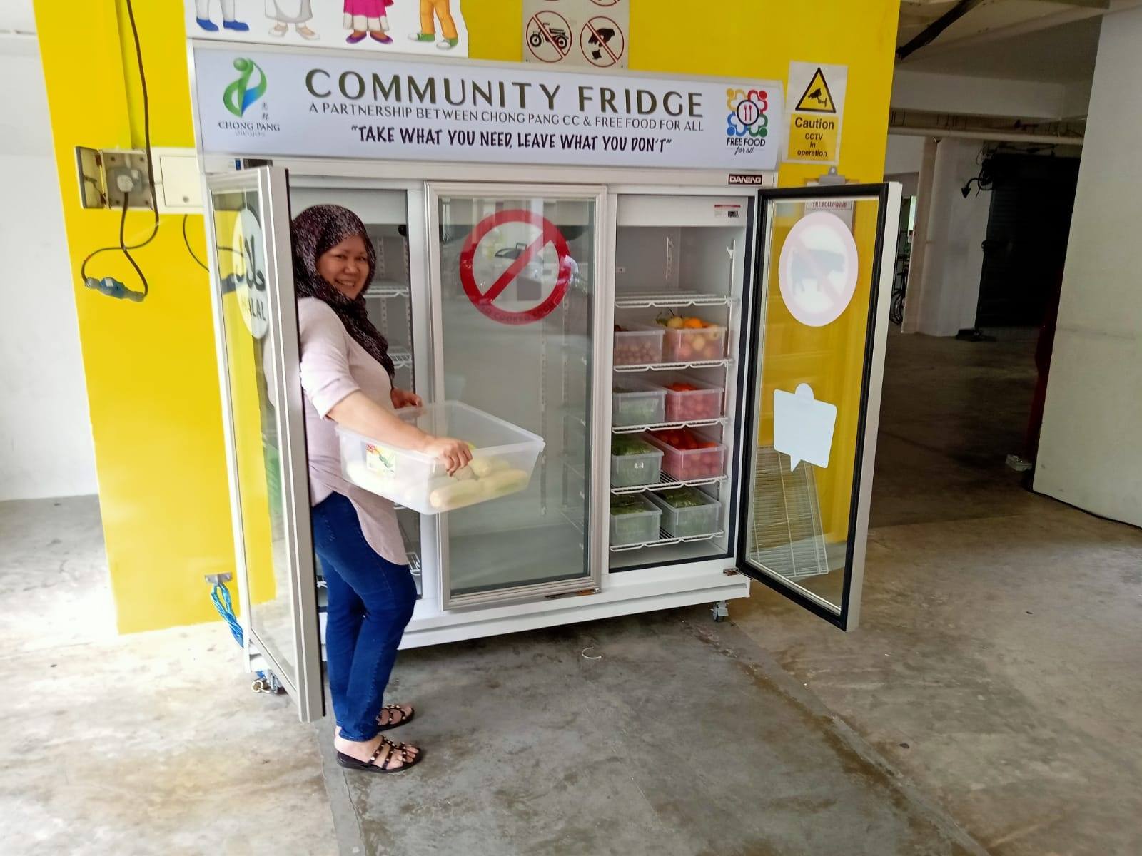 Volunteers stocking up the fridge. Photo courtesy: Free Food For All