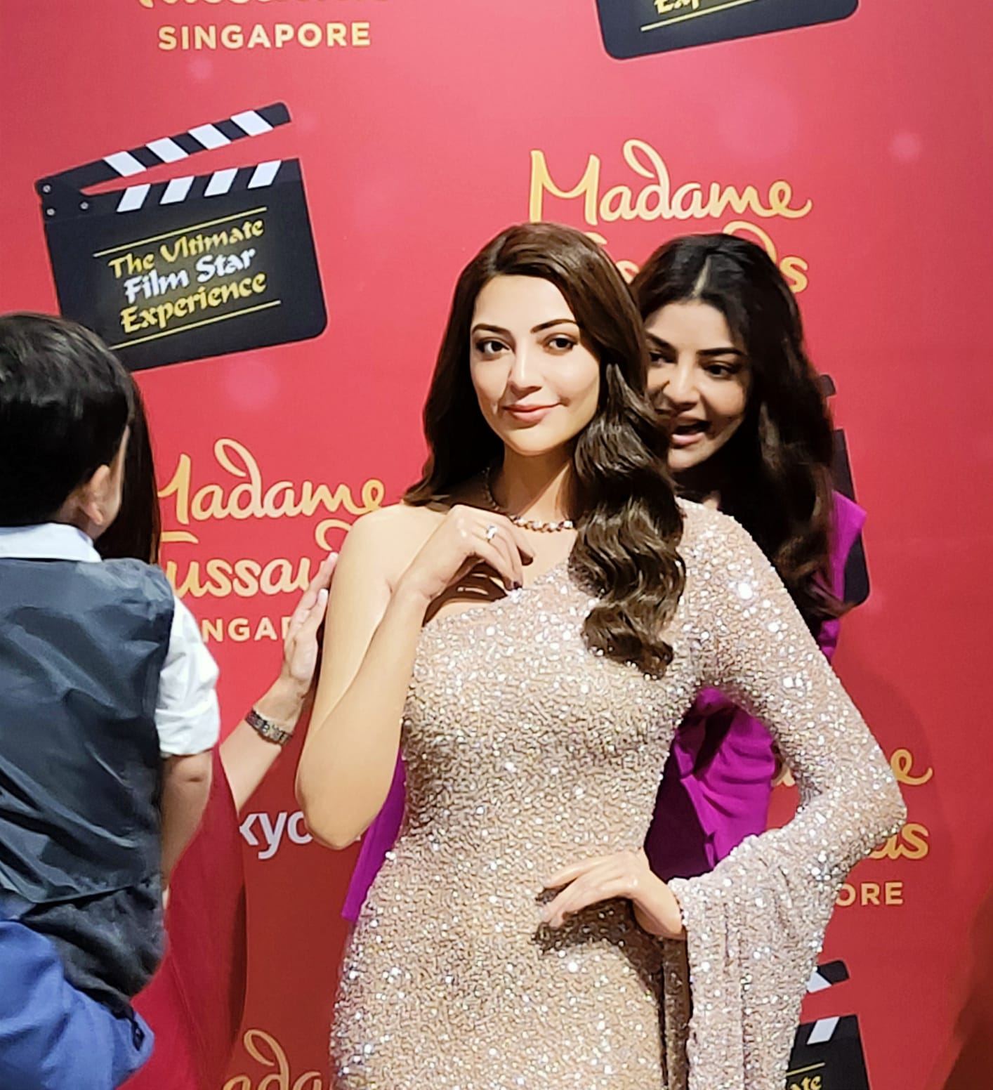 Kajal Aggarwal plays ‘Peekaboo’ from behind her wax statue with her nephew who could not contain his excitement as he searched for his ‘Maasi’. “Maasi kidhar hai?’ he could be heard asking many times before the unveiling. :) Photo: Connected to India 