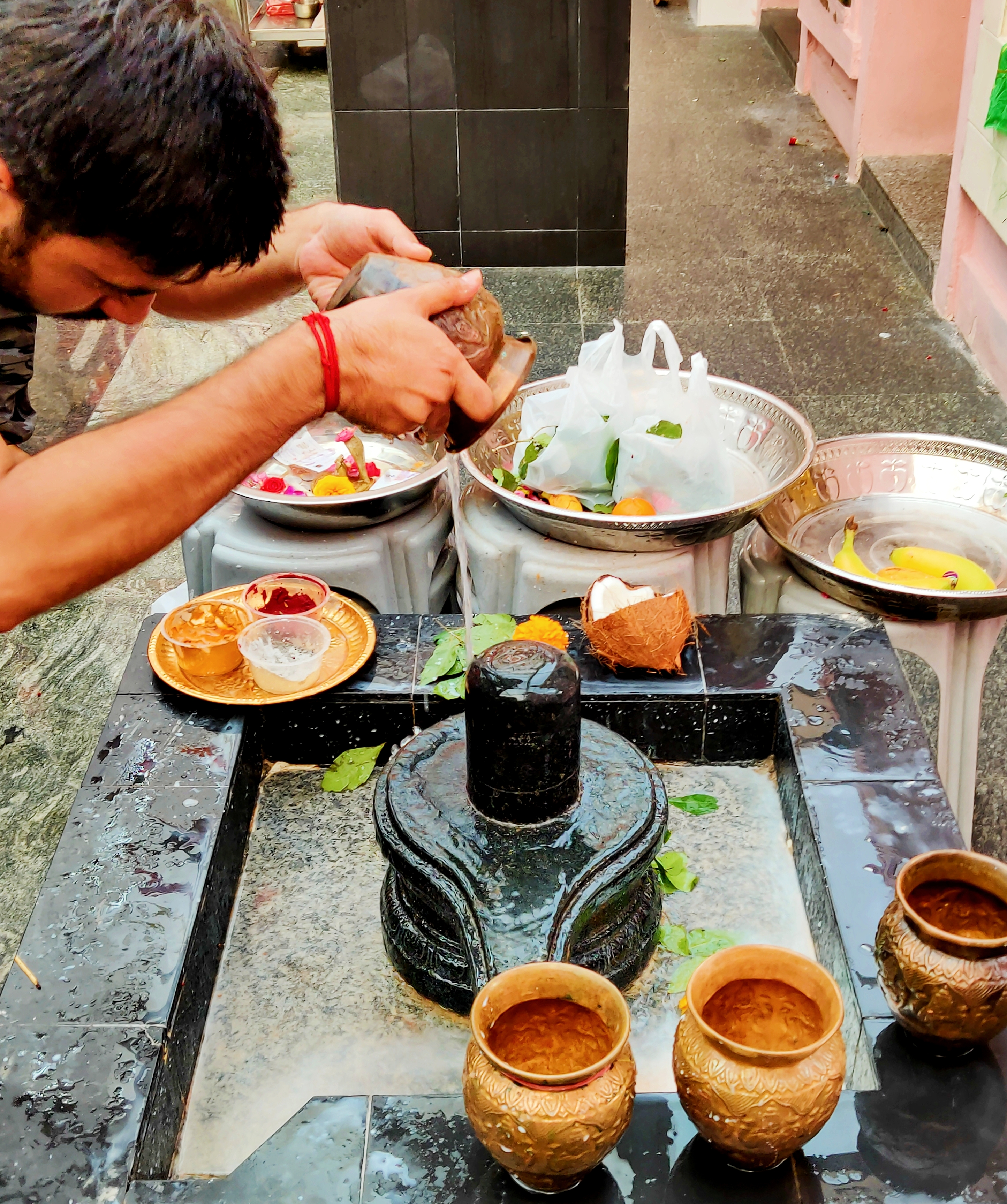 Devotees doing their own ''Abhisheka'' to the open-air Shivalinga within the premises of the Changi Ramar Temple. Photo: Connected to India
