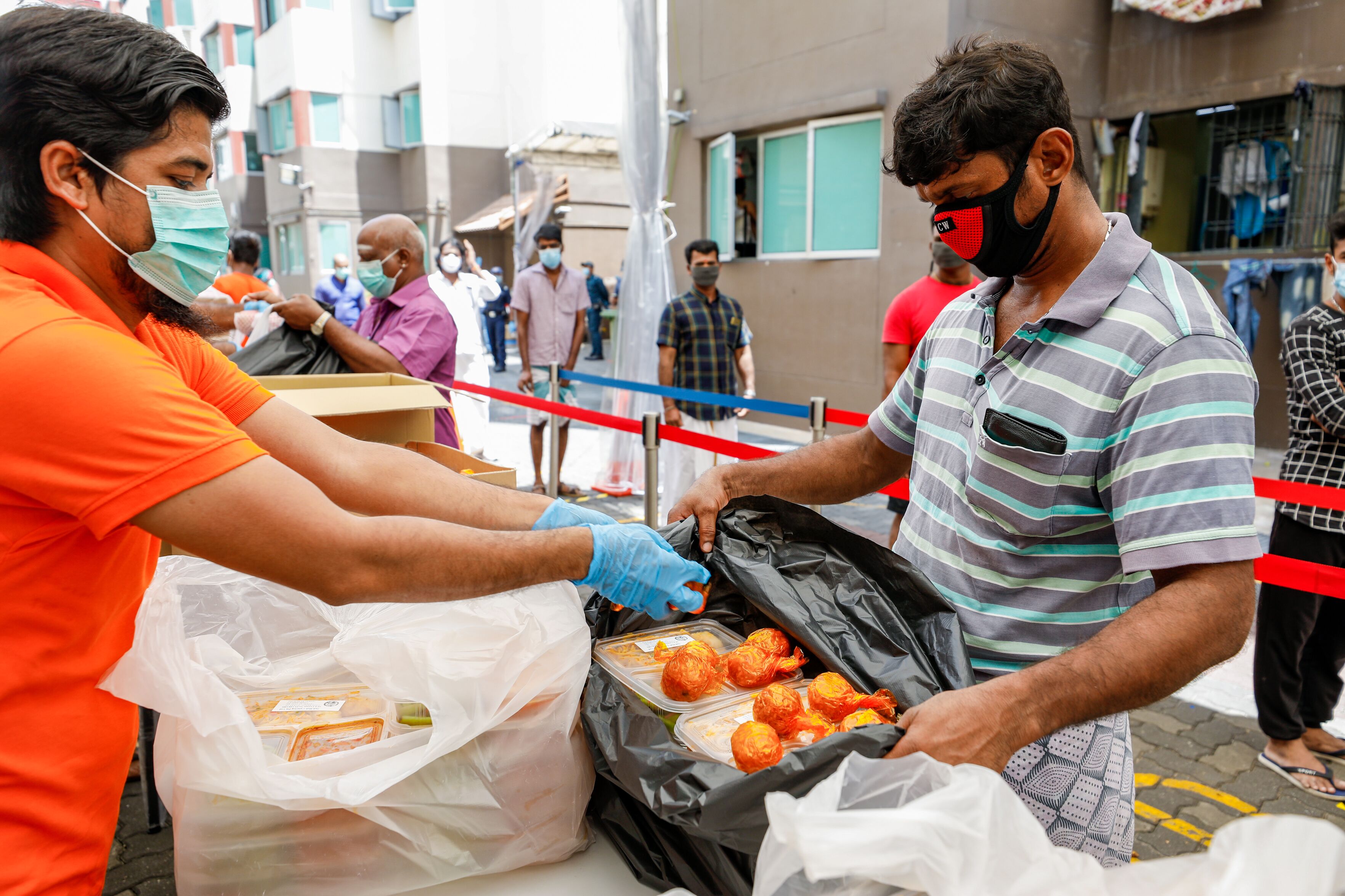Workers at Westlite Toh Guan collecting sweets during lunch. Photo courtesy: Ministry of Manpower (MOM)