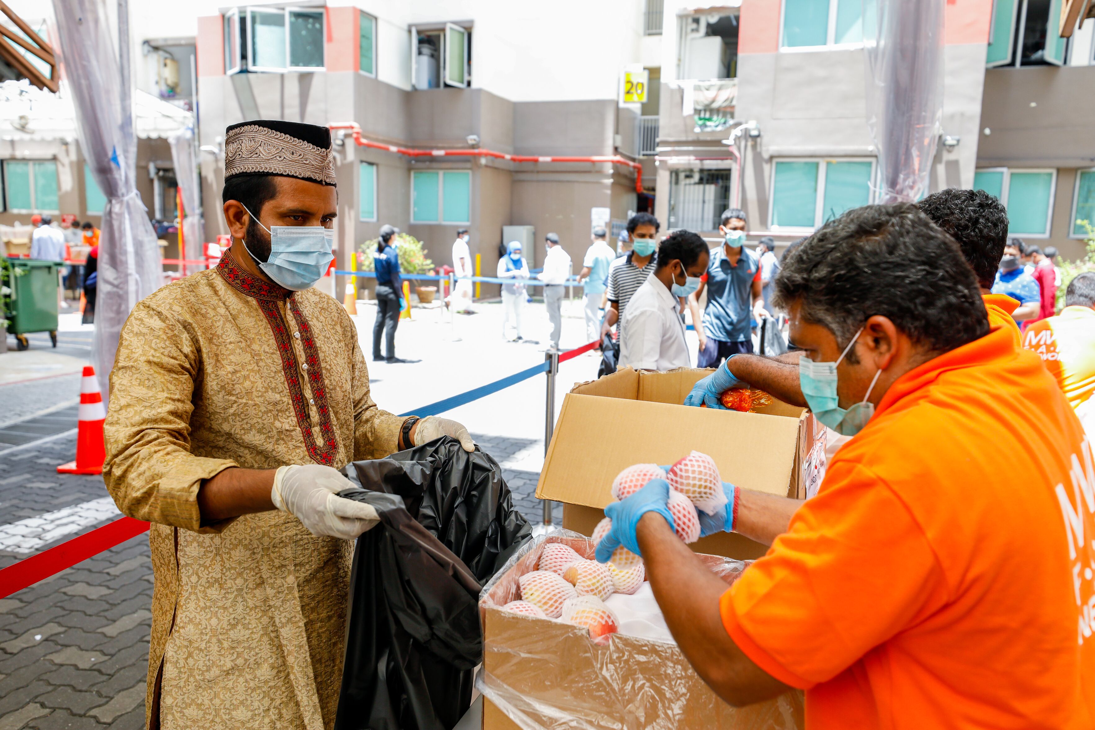 Workers at Westlite Toh Guan queuing up for lunch. Photo courtesy: Ministry of Manpower (MOM)