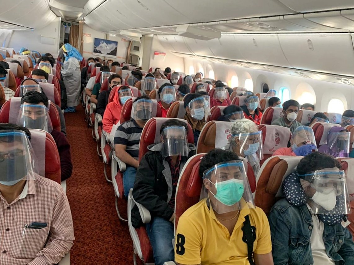 Passengers provided with masks and face shields on repatriation flights. Photo courtesy: Twitter/@HardeepSPuri