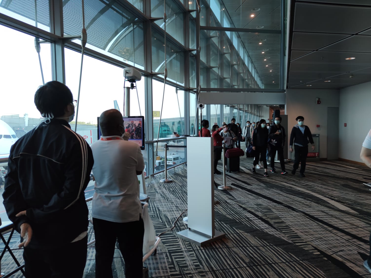 Passengers walking past the temperature scanners located in the terminals. Photo courtesy: Changi Airport