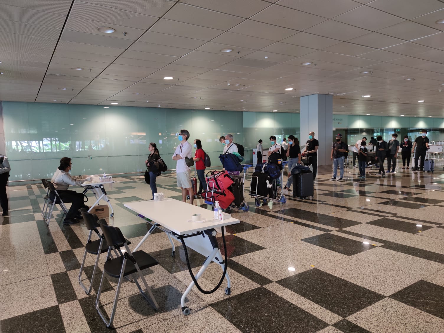Arriving passengers awaiting their SHN arrangements from CERTIS Cisco officers. Photo courtesy: Changi Airport