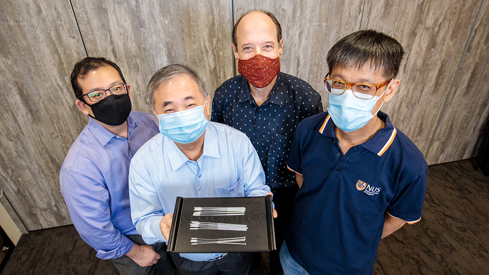 Professor Freddy Boey (centre, showing the swabs), and (from left) Dr Alfred Chia, Associate Professor David Allen, and Associate Professor Yen Ching-Chiuan are part of two NUS teams that developed three nasopharyngeal swab designs for COVID-19 testing. Photo courtesy: NUS