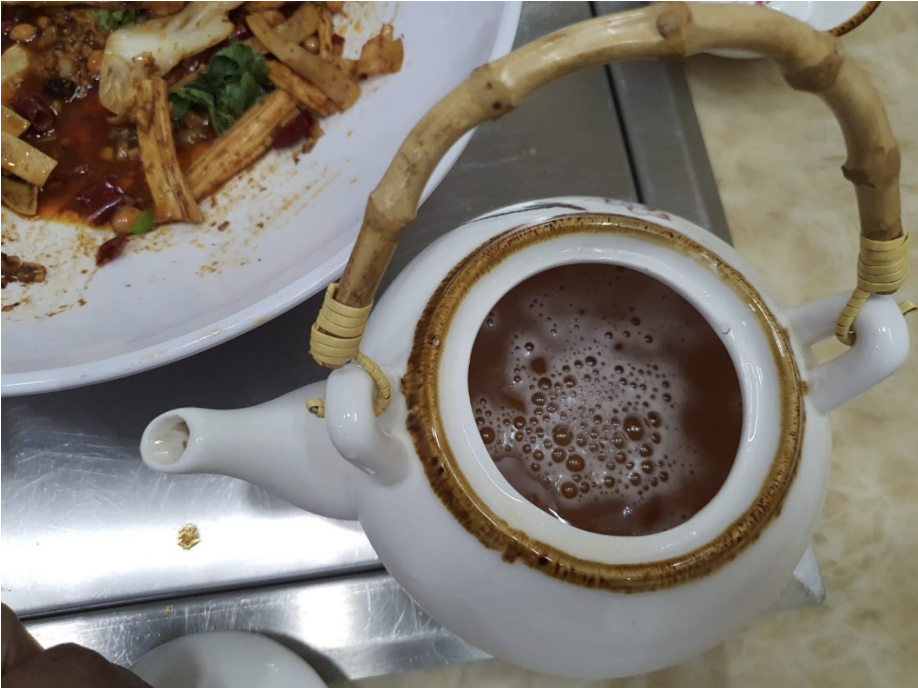 Sale and consumption of alcoholic beverages was observed after 10.30pm at S-Tripes Hotpot, with the beverages transferred into teapots and empty green tea bottles before being served to avoid detection. Photo courtedy: SFA