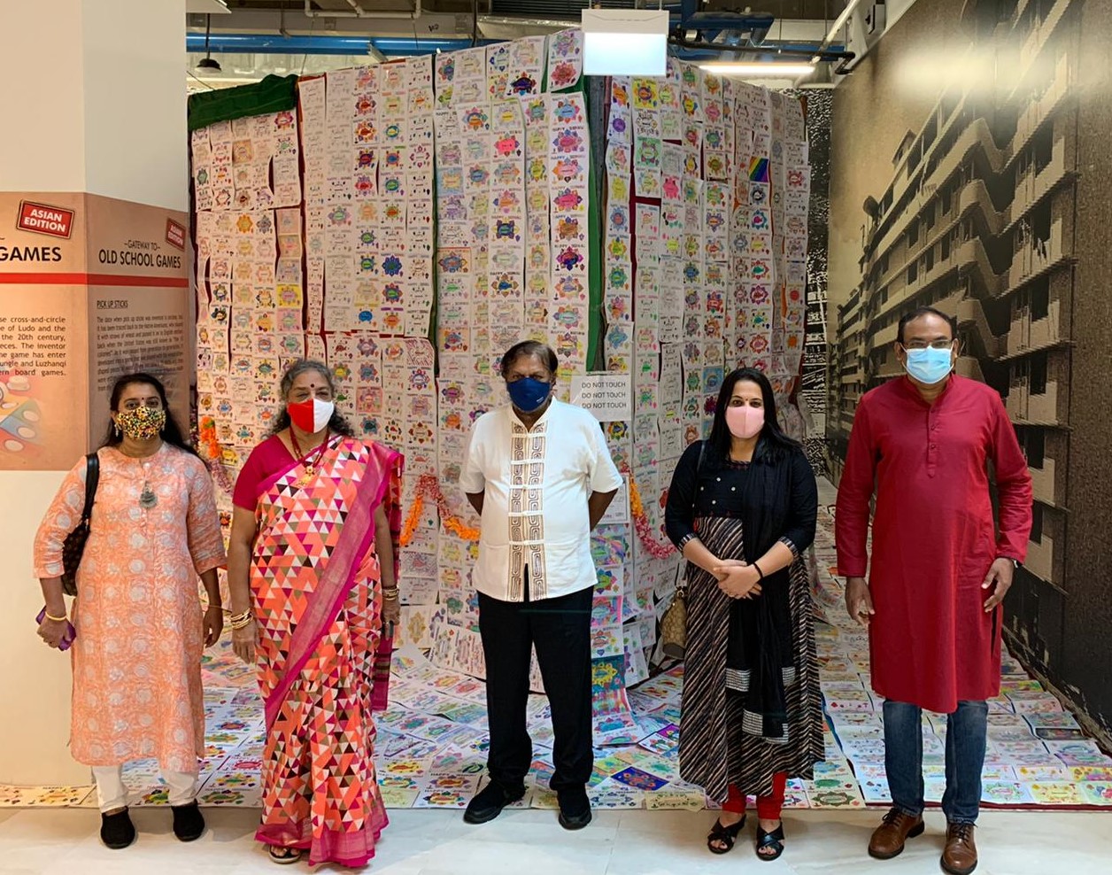 Mr and Mrs Vijaya Mohan (centre) with the management committee members of the Singapore Malayalaee Association whose members coloured 6000 of the cards.  Photo Courtesy: SingaRangoli 